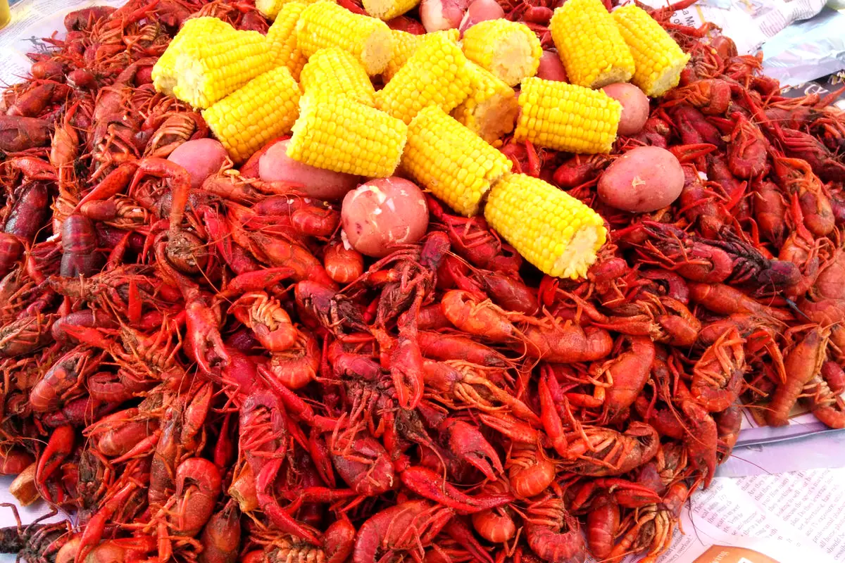 A bright spread of crawfish, corn, and potatoes