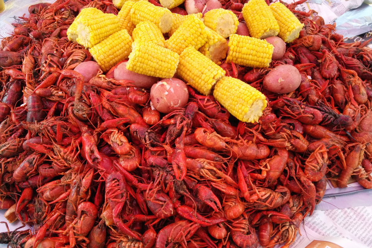 Crawfish, corn, and potatoes from an LSU SoCal boil, piled on newspaper